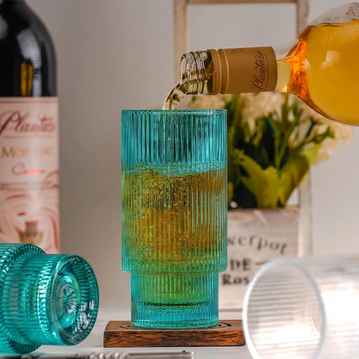 Modern ribbed drinking glass in aqua blue color suitable for juice, mocktails and cocktails