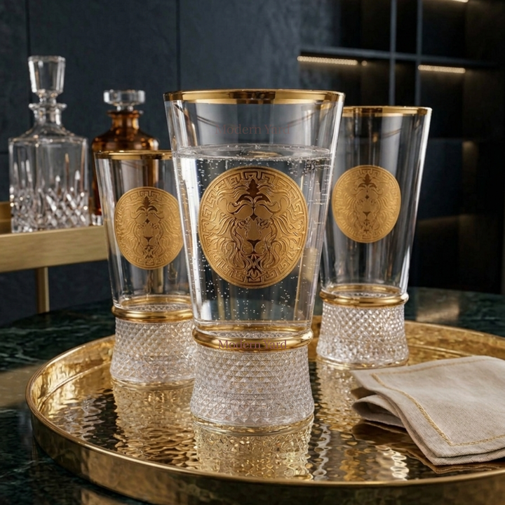 Luxury designer whiskey and cocktail glass with gold lion engraving and elegant crystal base.